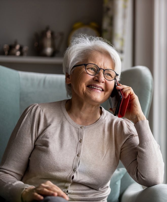 Elderly person enjoying a phone call
